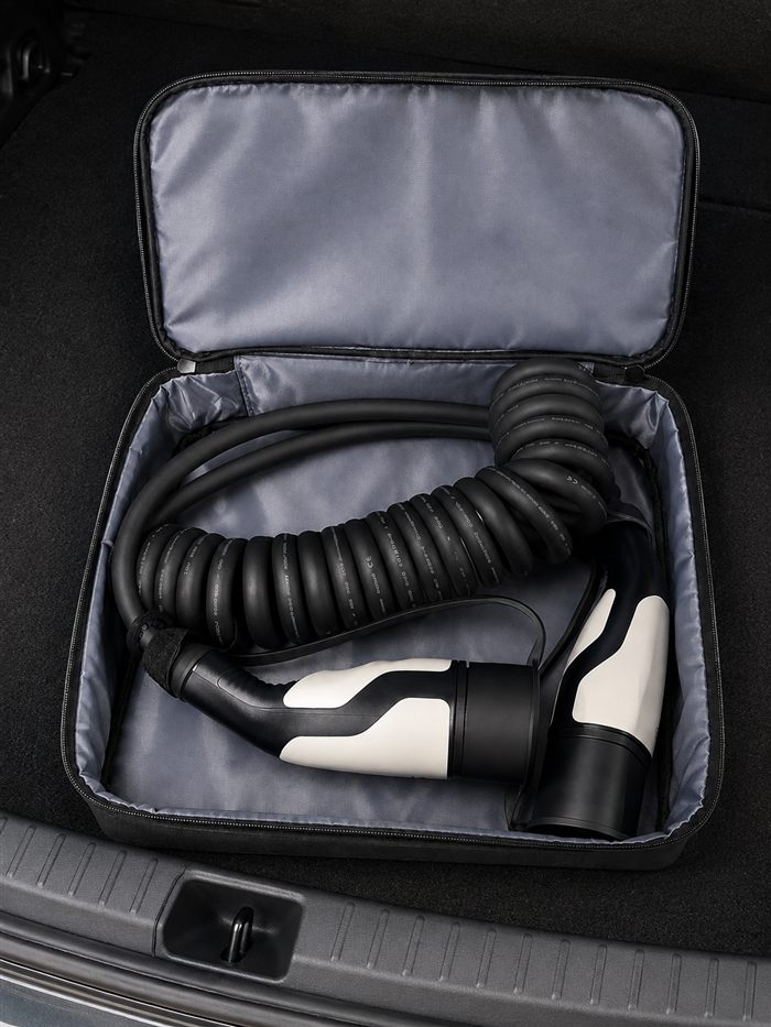 SINOX EV charging bag next to an electric car