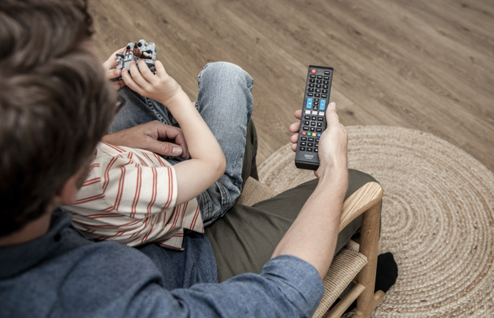 SINOX universal remote control being used in a living room